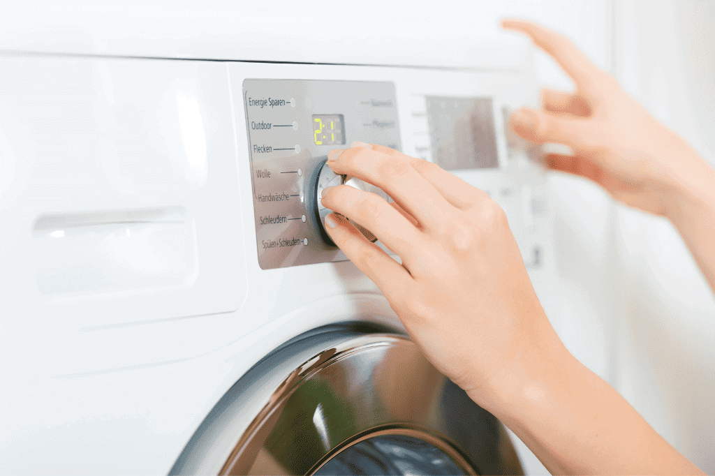 a women showing how to dry a dog bed with stuffing in the dryer.